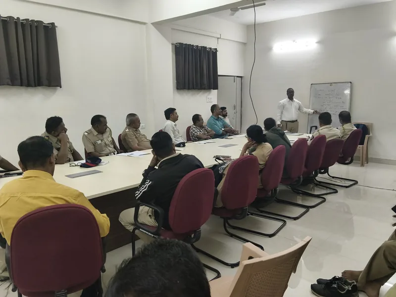A session in progress at a whiteboard, addressing uniformed police officers seated around a conference table